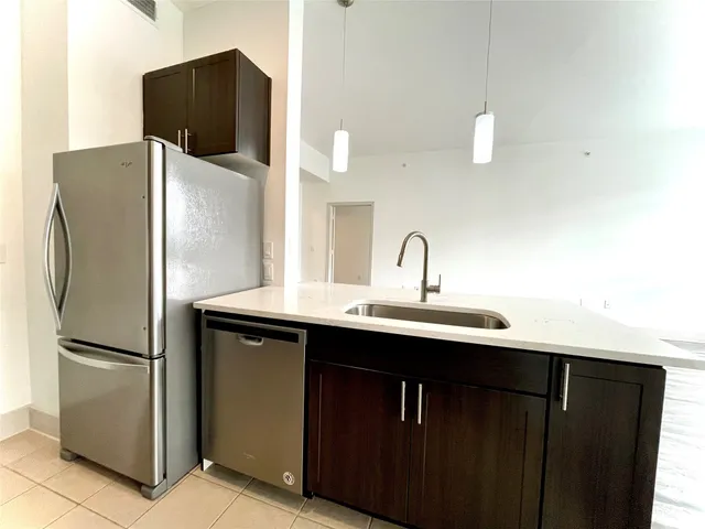 a kitchen with a sink and a refrigerator
