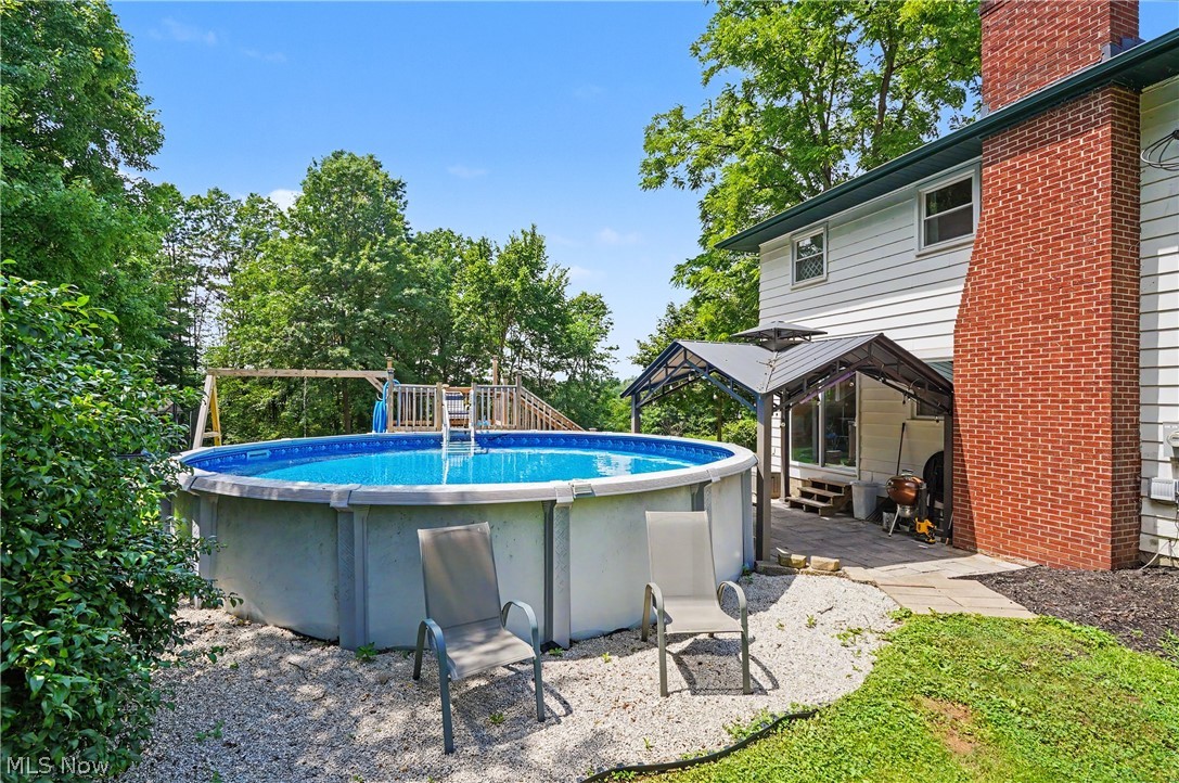 952 Ravenna Road Kent, OH 44240 - Photo 21 of 37 Above-ground pool with custom built deck and attached swing set.