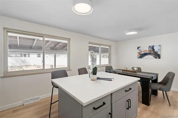 a view of a dining room with furniture and wooden floor