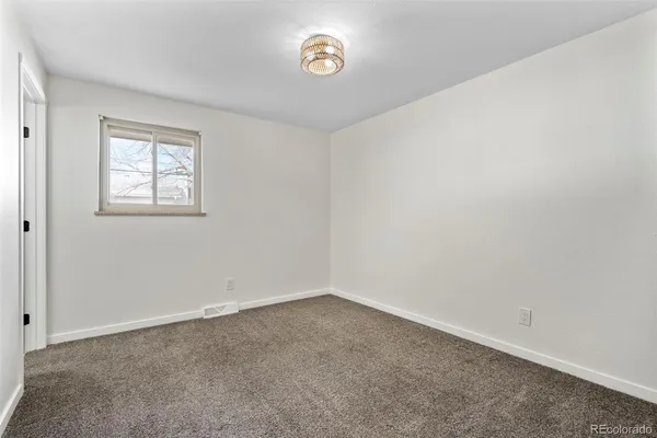 a view of an empty room and a window