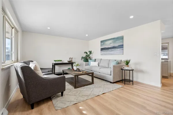 a living room with furniture potted plant and a window