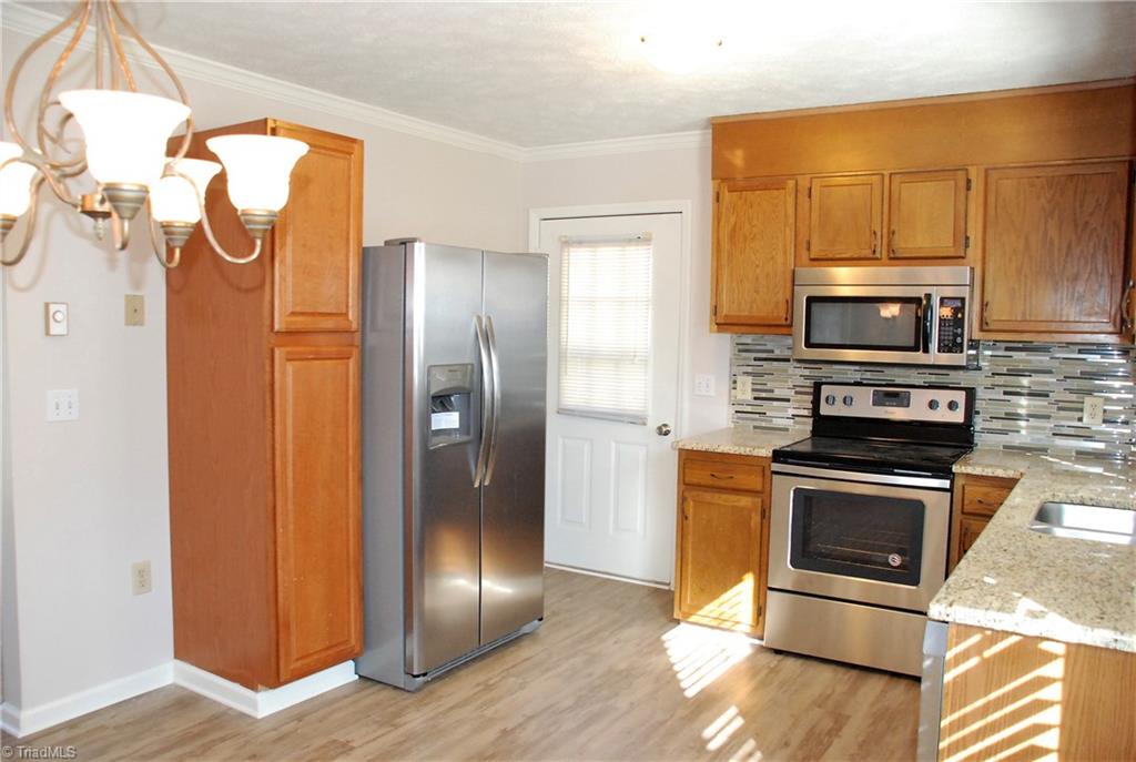 5974 Robinhood Road Pfafftown, NC 27040 - Photo 2 of 22 Kitchen with new appliances, granite & tile backsplash
