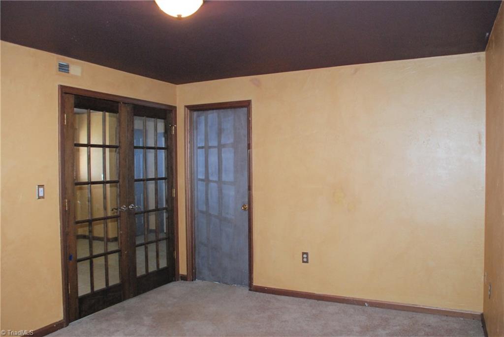 5974 Robinhood Road Pfafftown, NC 27040 - Photo 15 of 22 Playroom with french doors leading to den. Perfect for movies or video games! Solid door leads to workshop.