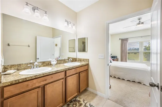 a bathroom with a granite countertop sink mirror and a bath tub