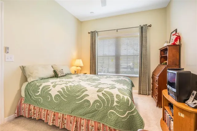 a bedroom with a bed and a flat tv screen