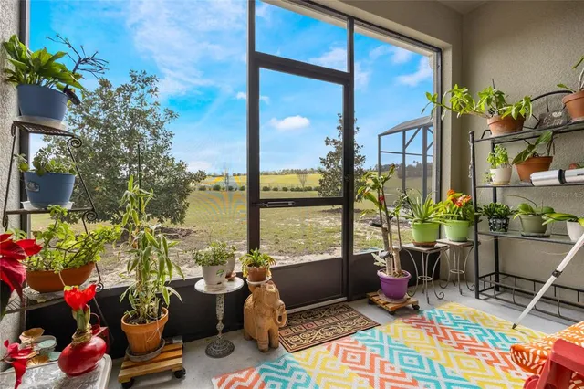 a view of a porch with furniture and garden