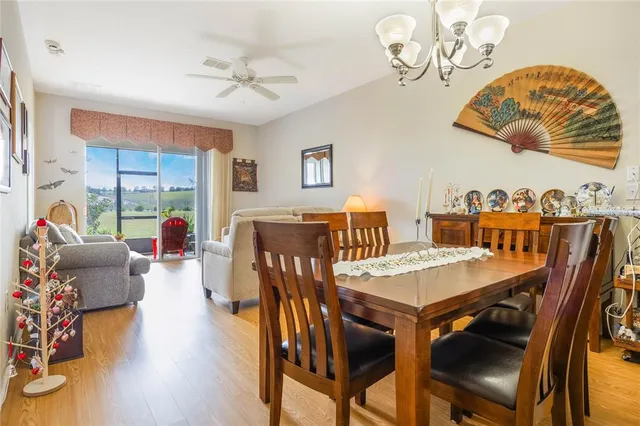 a view of a dining room with furniture wooden floor and a chandelier