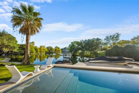 a view of swimming pool with a table and chairs