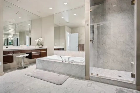 a large bathroom with a large mirror vanity and shower