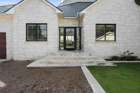 a view of brick house with a yard