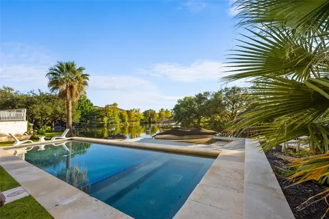a view of swimming pool with outdoor seating and plants