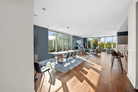 a living room with furniture a large window and a table