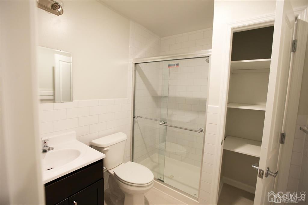 3301 Hana Road Edison, NJ 08817 - Photo 17 of 39 a bathroom with a granite countertop sink toilet and shower