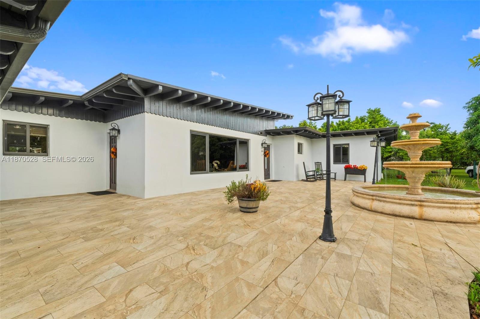 a view of a house with backyard and porch