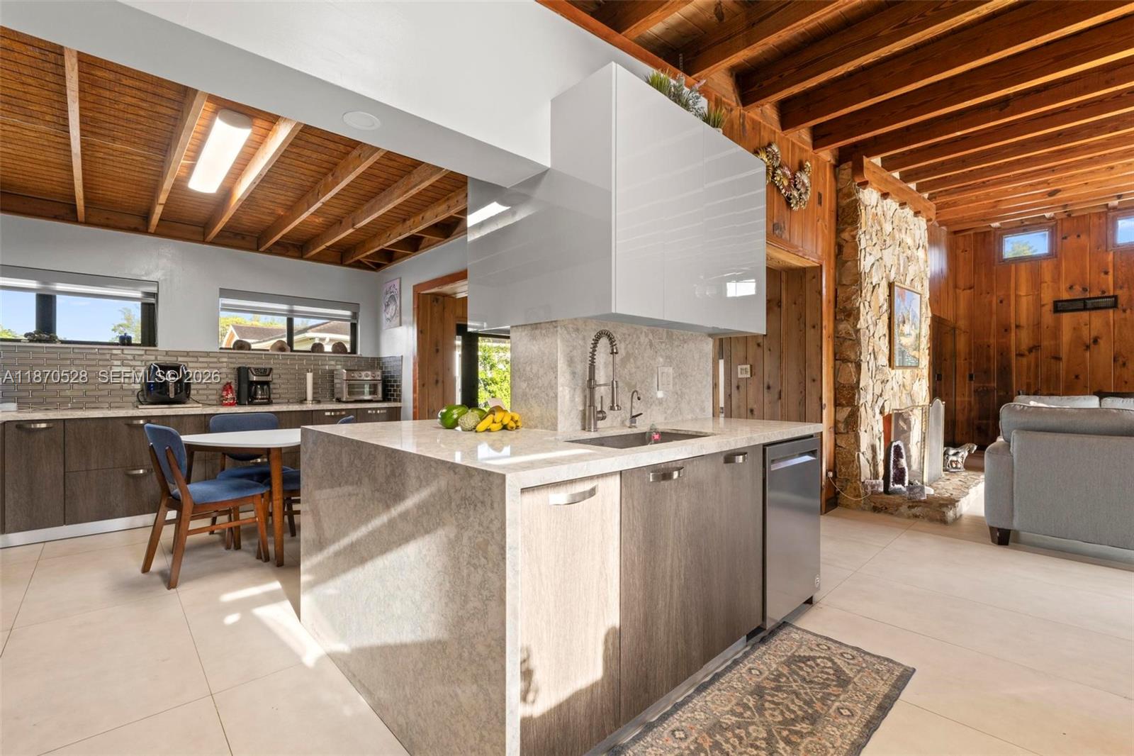 6539 Southwest 84th Avenue Miami, FL 33143 - Photo 11 of 25 a kitchen with a sink and chairs