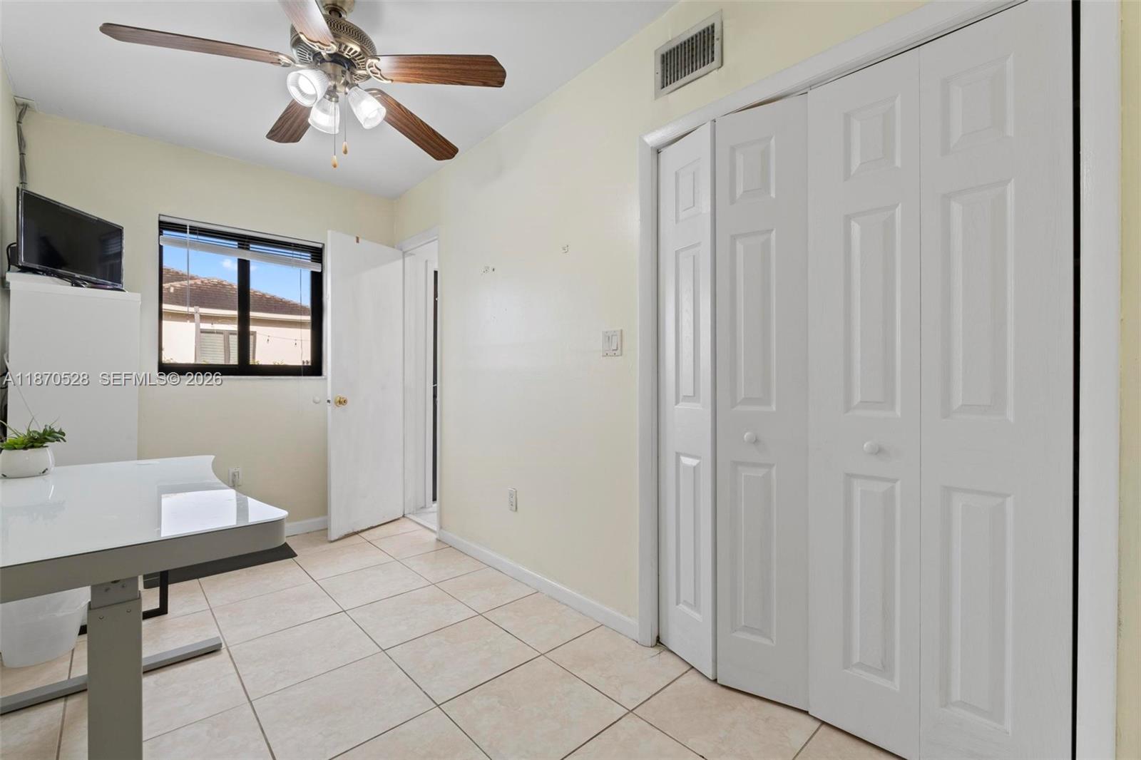 6539 Southwest 84th Avenue Miami, FL 33143 - Photo 17 of 25 a view of a livingroom with a chandelier fan and windows