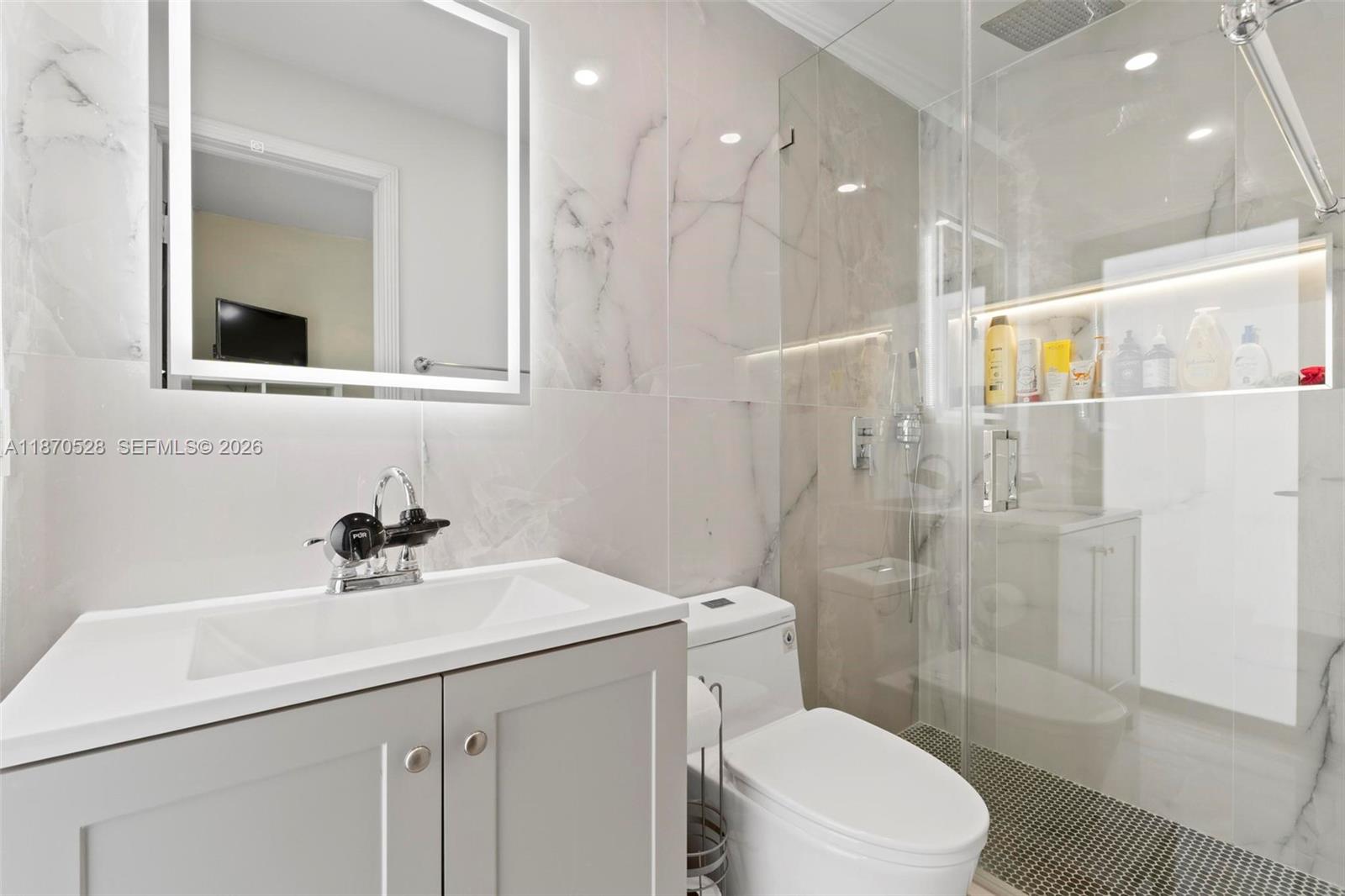 6539 Southwest 84th Avenue Miami, FL 33143 - Photo 19 of 26 a bathroom with a sink a toilet and shower