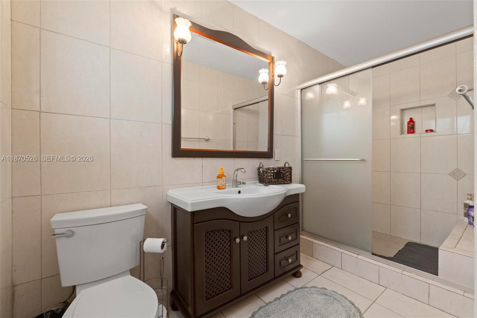 6539 Southwest 84th Avenue Miami, FL 33143 - Photo 20 of 25 a bathroom with a sink a toilet and shower