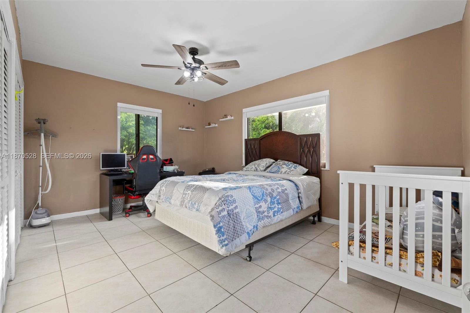 6539 Southwest 84th Avenue Miami, FL 33143 - Photo 21 of 25 a bedroom with a bed and a chandelier
