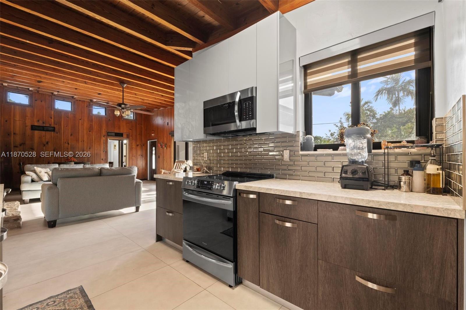 6539 Southwest 84th Avenue Miami, FL 33143 - Photo 8 of 25 a kitchen with stainless steel appliances granite countertop a stove a sink and a microwave