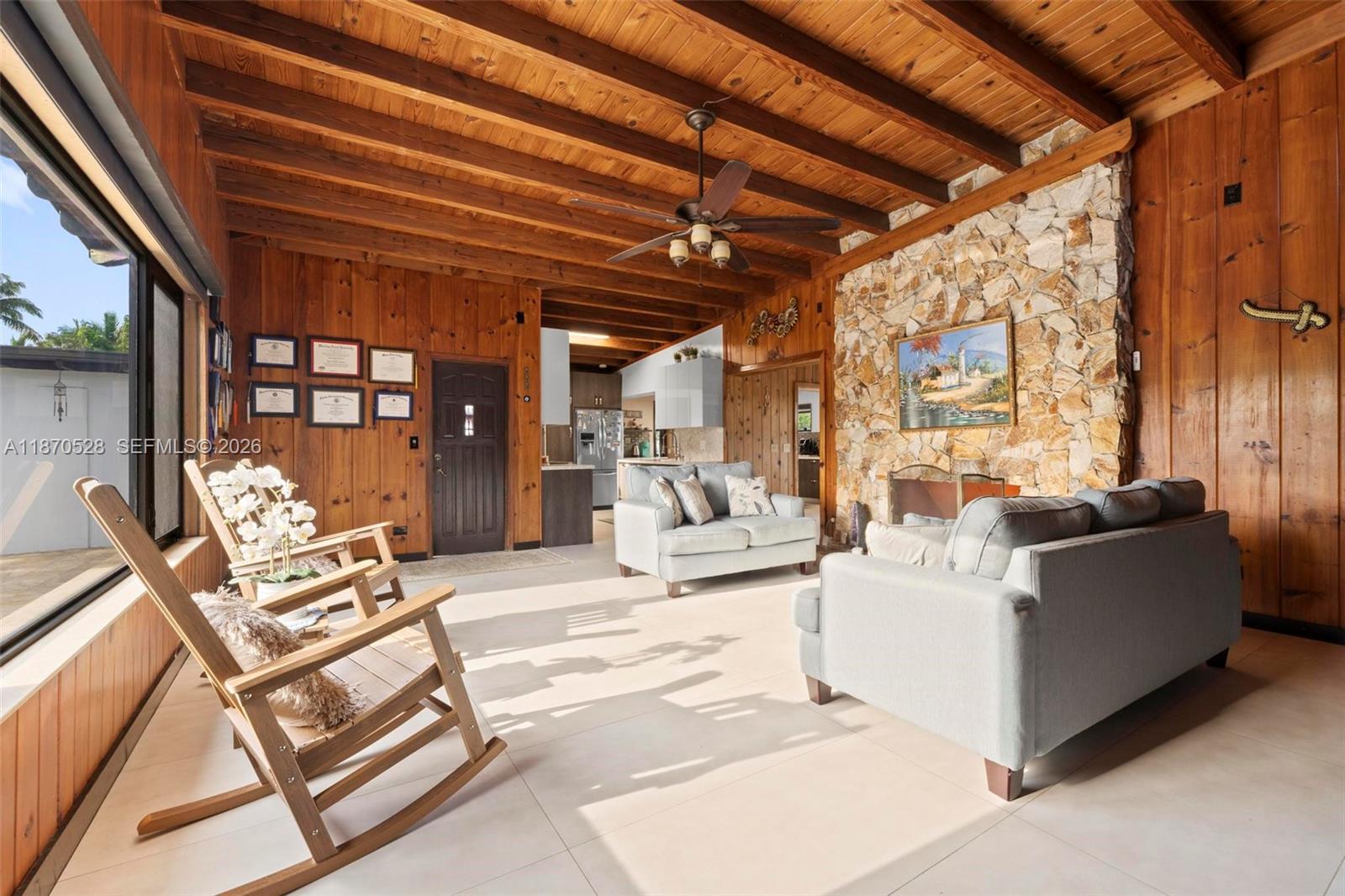 6539 Southwest 84th Avenue Miami, FL 33143 - Photo 10 of 26 a living room with furniture and a chandelier