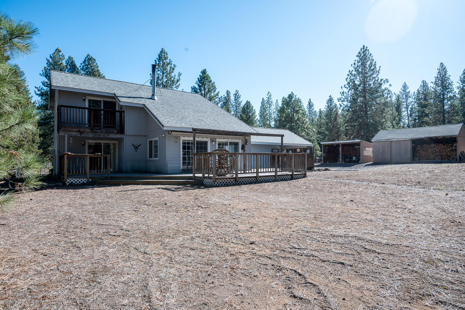 19793 Buck Canyon Road Bend, OR 97702 - Photo 21 of 33 a house with trees in the background