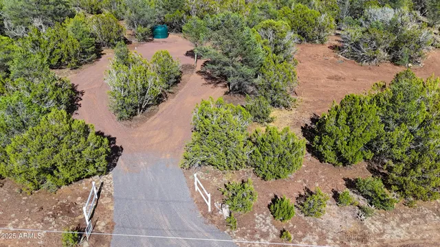 an aerial view of a house with a yard and garden