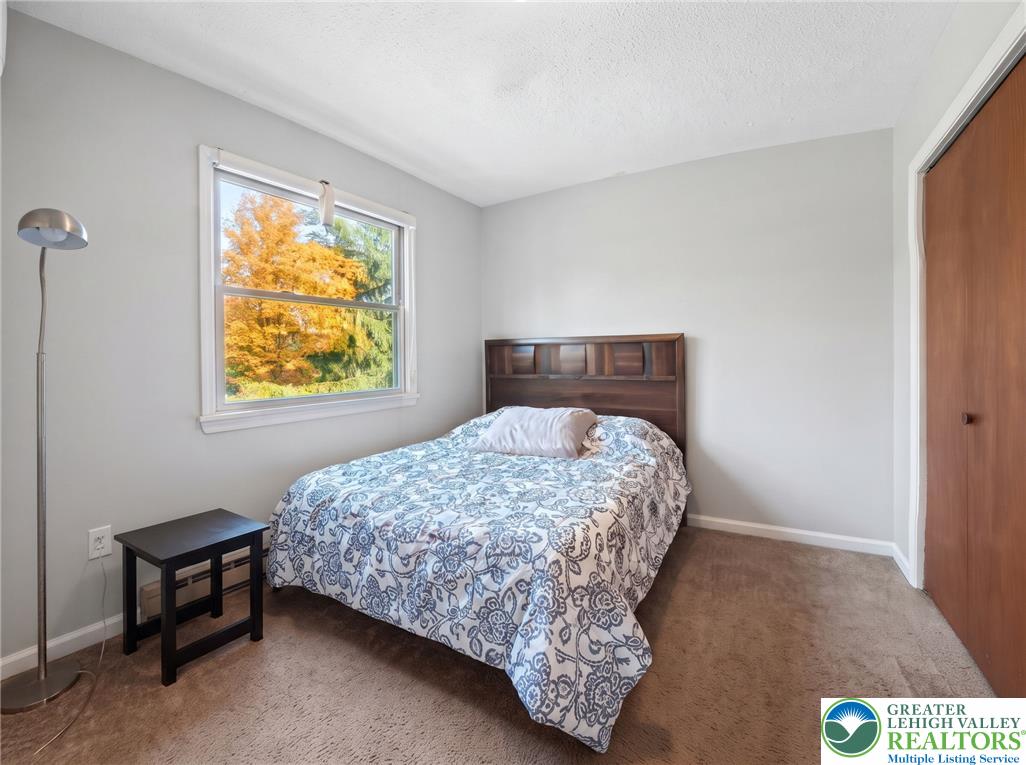 1605 Ridgeview Drive Lake Ariel, PA 18436 - Photo 21 of 40 Plentiful natural light fills a cozy bedroom featuring wall-to-wall carpeting and wood frames.