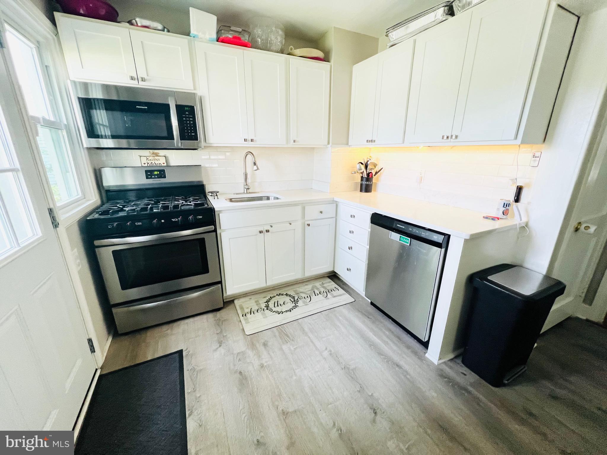 8111 Hillendale Road Baltimore, MD 21234 - Photo 8 of 21 a kitchen with cabinets and steel appliances