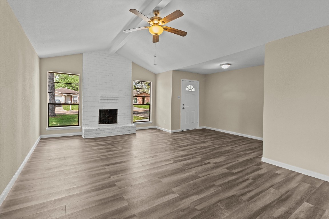 wooden floor in an empty room with a window