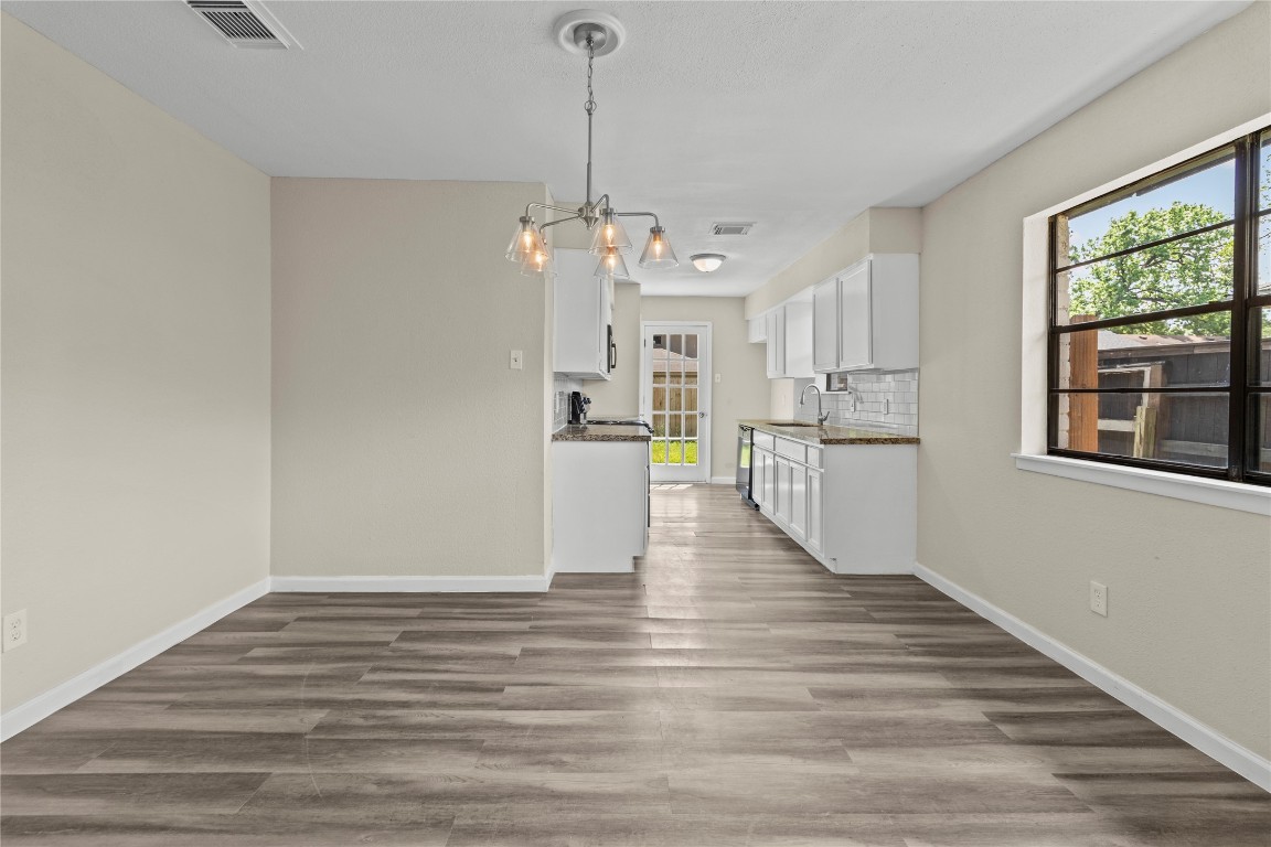5026 Fitzwater Drive Spring, TX 77373 - Photo 6 of 14 a view of a kitchen with wooden floor and windows