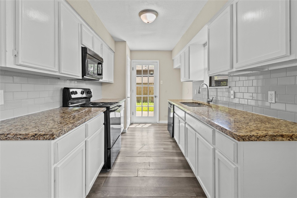 5026 Fitzwater Drive Spring, TX 77373 - Photo 7 of 14 a kitchen with stainless steel appliances granite countertop a sink stove and cabinets