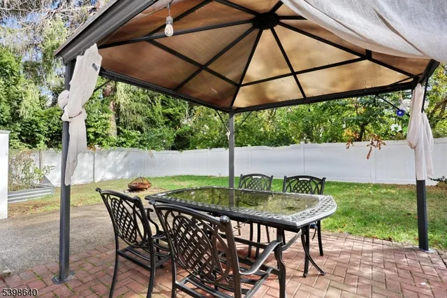 a backyard of a house with table and chairs