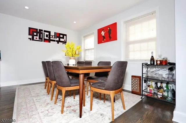 a dining room with furniture a rug and wooden floor