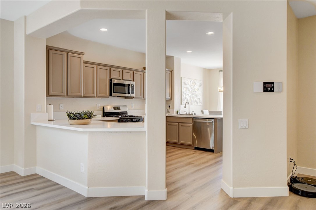 2649 Rue Marquette Avenue Henderson, NV 89044 - Photo 19 of 55 A well-appointed kitchen with an integrated breakfast bar and stainless steel appliances awaits.