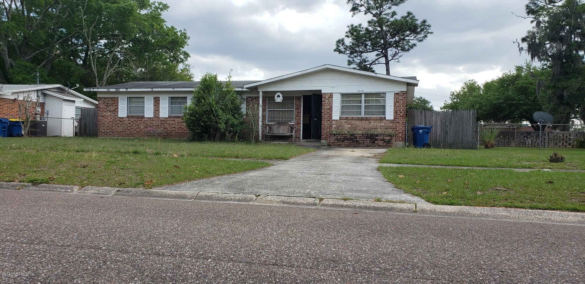 1040 Player Road Jacksonville, FL 32218 - Photo 1 of 12 a front view of a house with a yard and garage