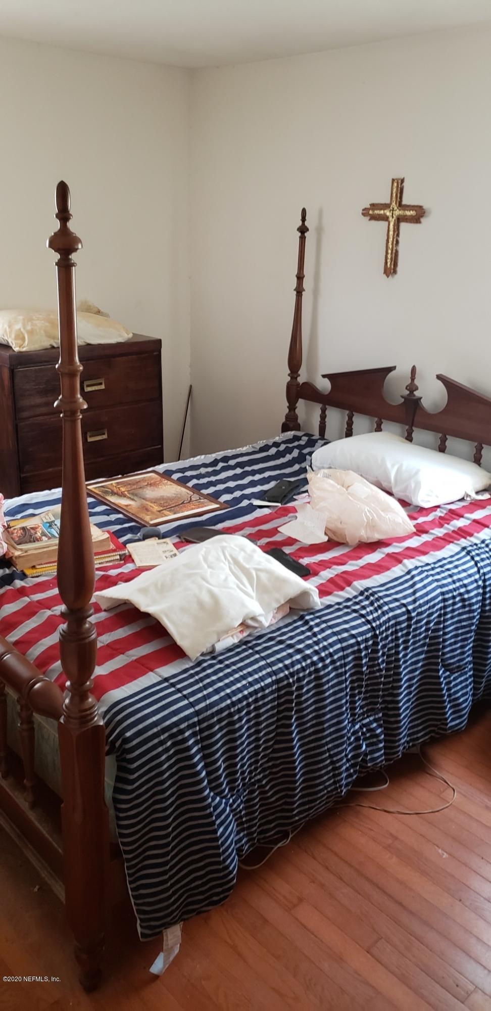 1040 Player Road Jacksonville, FL 32218 - Photo 11 of 12 a bedroom with a bed and wooden floor