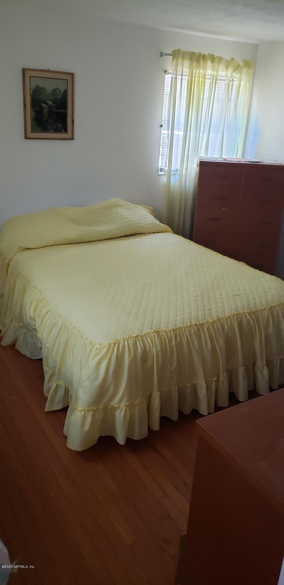 1040 Player Road Jacksonville, FL 32218 - Photo 3 of 12 a bed sitting in a bedroom next to a window