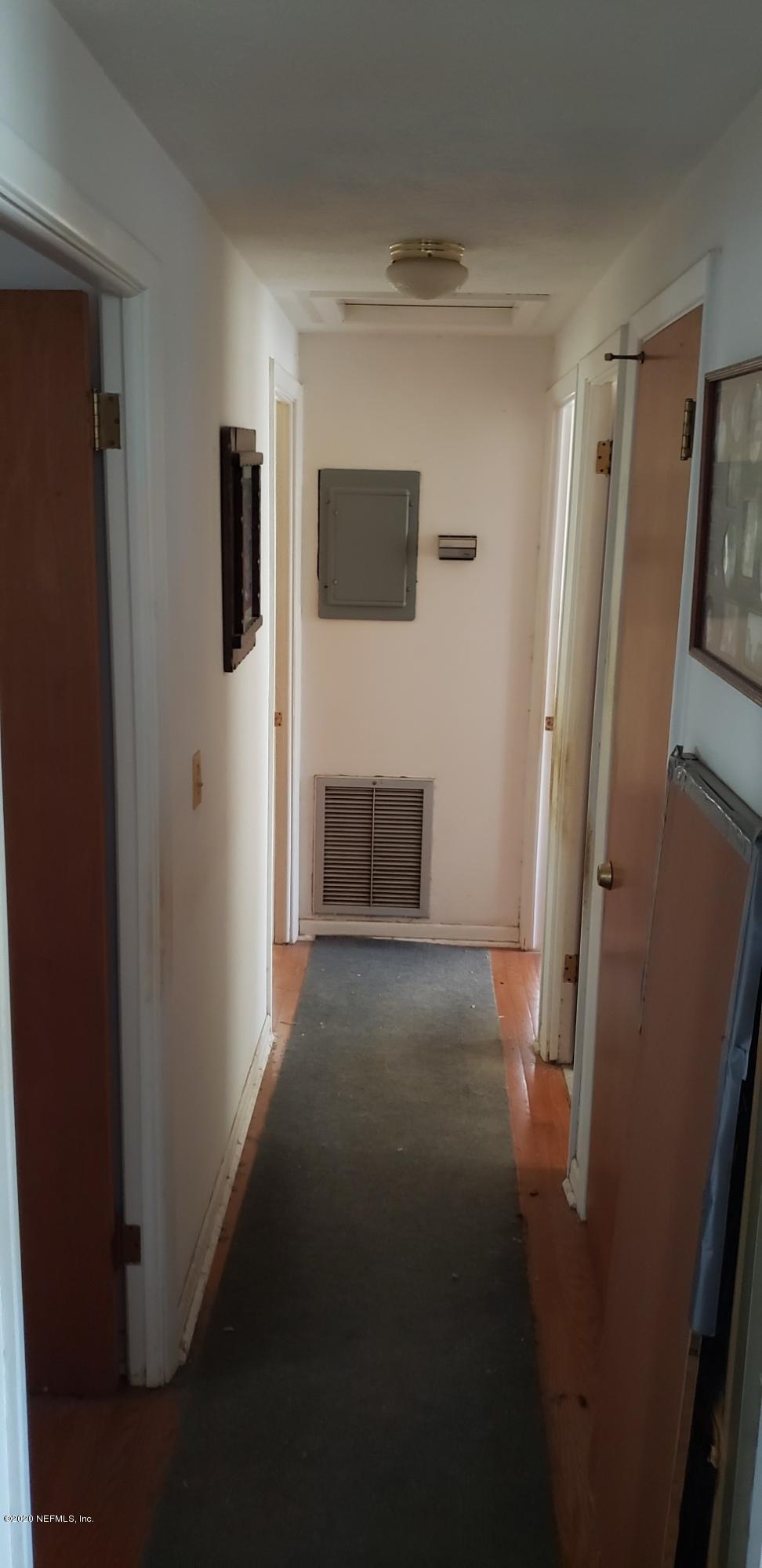 1040 Player Road Jacksonville, FL 32218 - Photo 8 of 12 a view of empty room with wooden floor and window