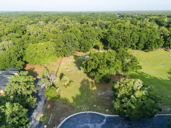 an aerial view of residential house with outdoor space and swimming pool