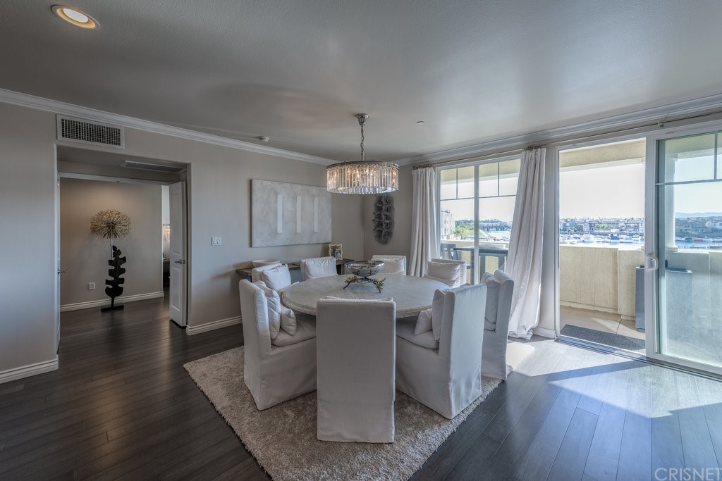 4346 Tradewinds Drive Oxnard, CA 93035 - Photo 8 of 35 a dining room with wooden floor and large windows