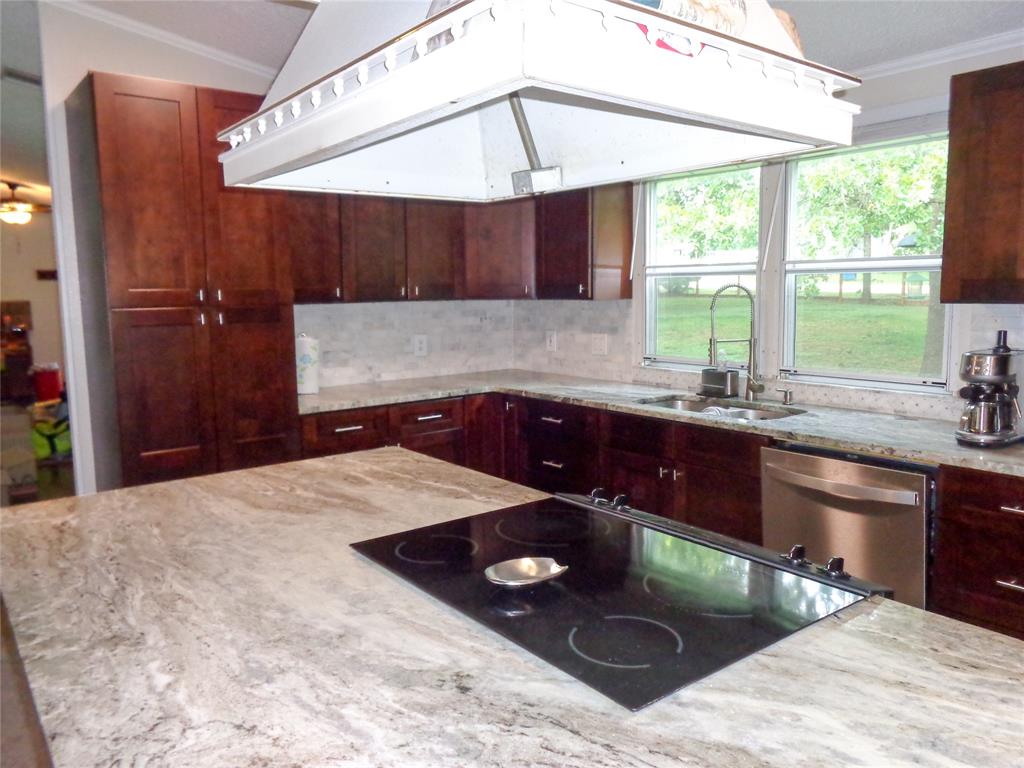 5525 Cedar Oaks Road Grandview, TX 76050 - Photo 7 of 40 Kitchen featuring new real wood soft close cabinetry, granite countertops, a stainless-steel sink with a gooseneck faucet, a tile backsplash, wood-finish flooring, and custom designed/fabricated Island