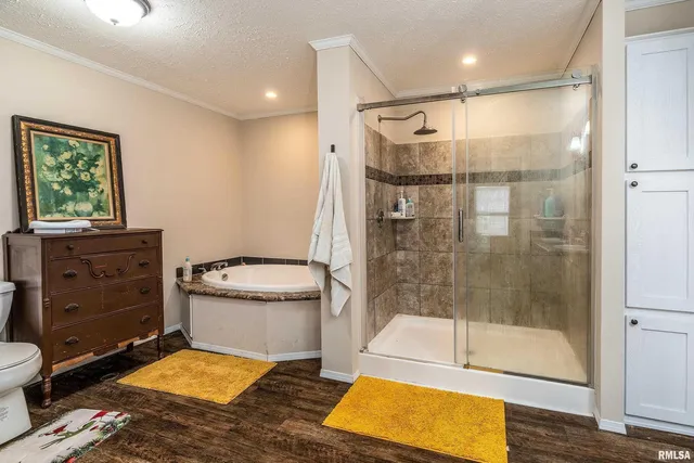 a bathroom with a granite countertop toilet sink and mirror