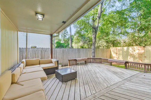 a balcony with wooden floor and furniture
