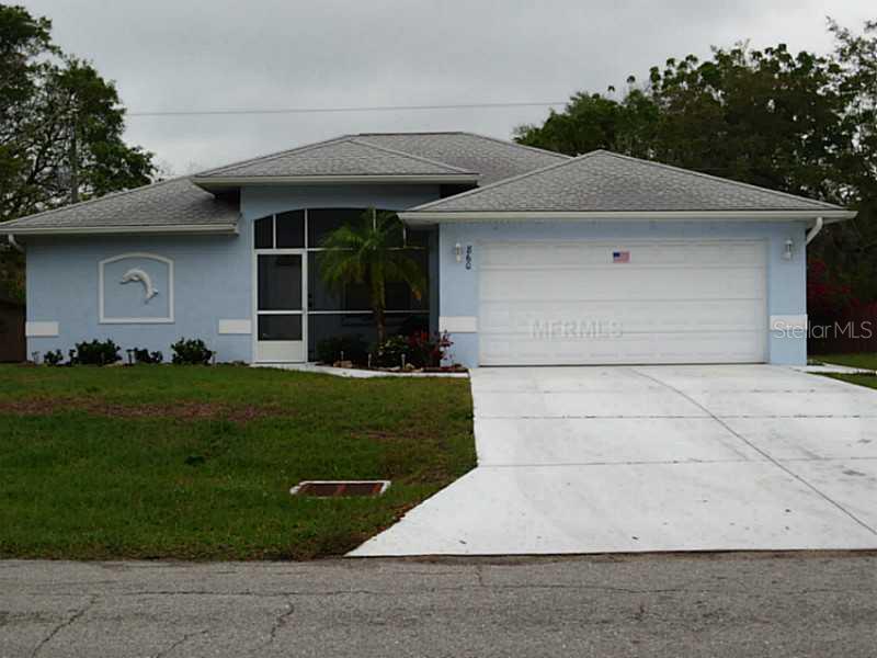 860 Flamingo Road Venice, FL 34293 - Photo 1 of 1 a front view of a house with a garden and yard