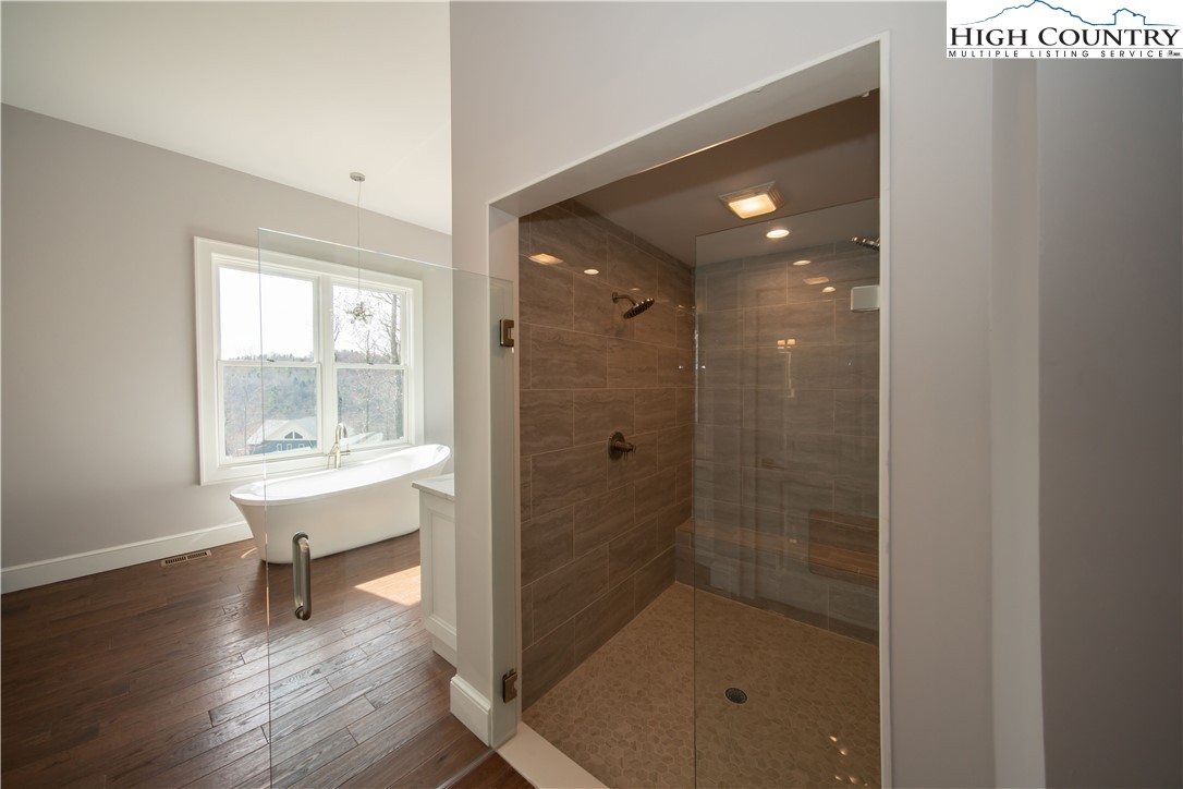 280 Boulder Cay Road Boone, NC 28607 - Photo 23 of 33 a bathroom with a bathtub shower sink and mirror