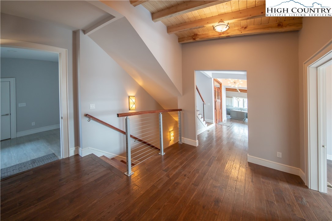 280 Boulder Cay Road Boone, NC 28607 - Photo 26 of 33 a view of a hallway with wooden floor and stairs
