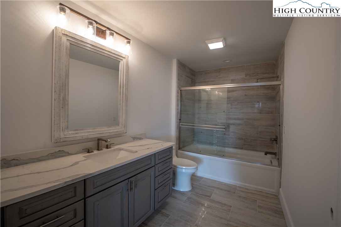 280 Boulder Cay Road Boone, NC 28607 - Photo 28 of 33 a bathroom with a shower a sink and a toilet