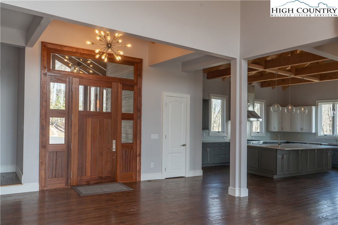 280 Boulder Cay Road Boone, NC 28607 - Photo 5 of 33 a view of a hallway with wooden floor and a kitchen