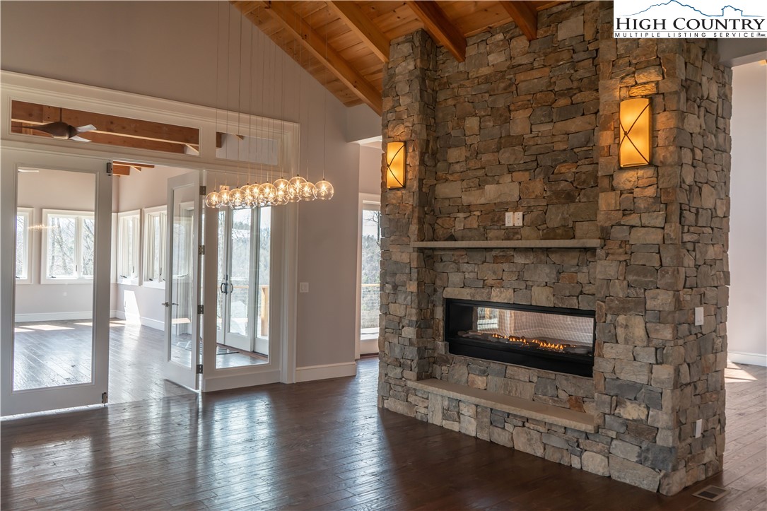 280 Boulder Cay Road Boone, NC 28607 - Photo 7 of 33 a living room with wooden floor and a fireplace